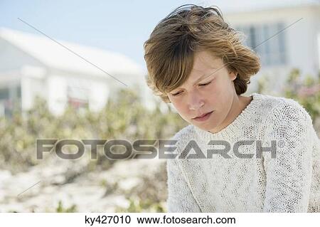 Stock Image - Close-up of a boy looking serious. Fotosearch