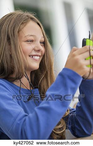 Close-up of a girl using a mobile phone in classroom View Large Photo Image Stock Image - Close-up of a girl using a mobile phone in classroom. Fotosearch