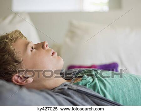 Stock Photography - Close-up of a teenage boy lost in thoughts. Fotosearch