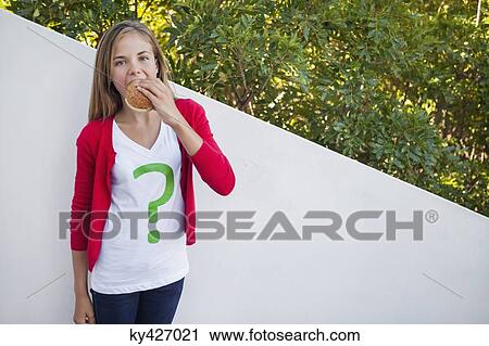 Girl eating hamburger View Large Photo Image Stock Image - Girl eating hamburger. Fotosearch