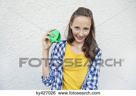 Stock Photograph - Girl holding an empty purse. Fotosearch