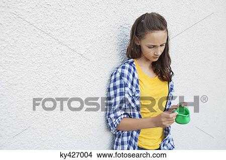 Girl looking at an empty purse View Large Photo Image Picture - Girl looking at an empty purse. Fotosearch