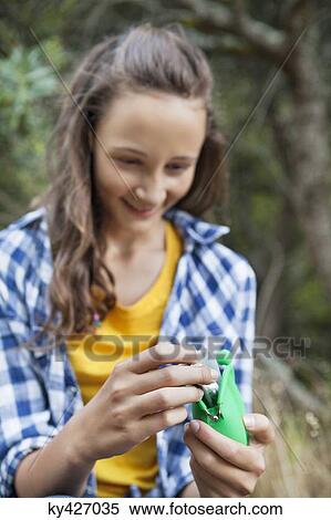 Happy girl looking at pocket money View Large Photo Image Stock Photography - Happy girl looking at pocket money. Fotosearch