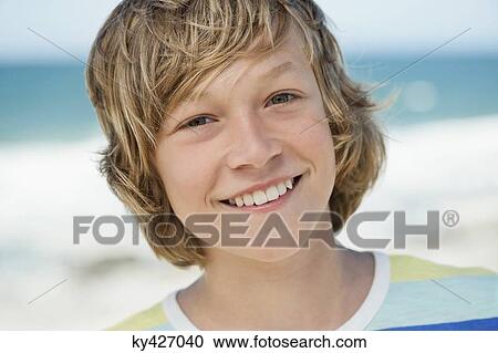 Portrait of a boy smiling on the beach View Large Photo Image Stock Image - Portrait of a boy smiling on the beach. Fotosearch