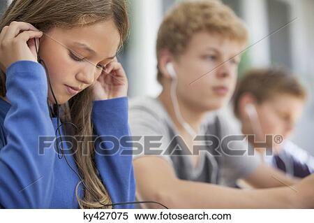 Students listening to music in a classroom View Large Photo Image Stock Photography - Students listening to music in a classroom. Fotosearch