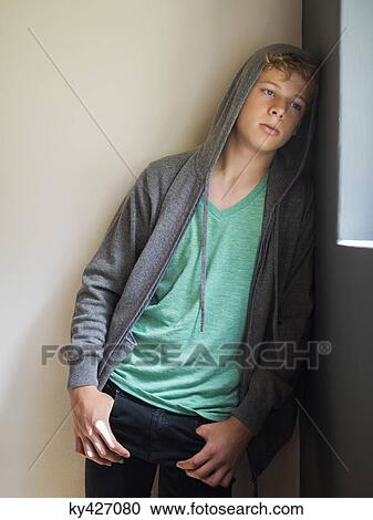 Teenage boy leaning against a wall and thinking View Large Photo Image Stock Image - Teenage boy leaning against a wall and thinking. Fotosearch