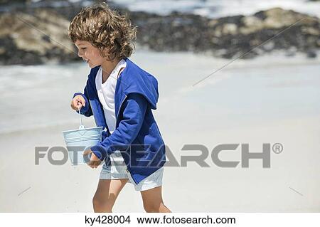 Boy playing on the beach View Large Photo Image Picture - Boy playing on the beach. Fotosearch