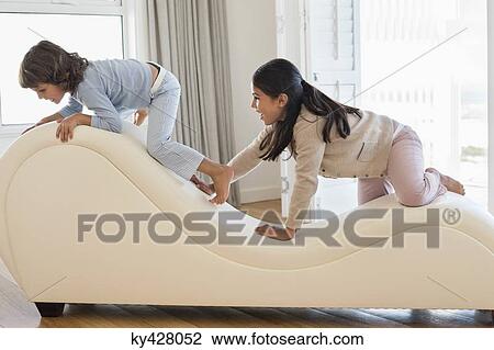 Brother and his sister playing on a chaise longue View Large Photo Image Stock Image - Brother and his sister playing on a chaise longue. Fotosearch
