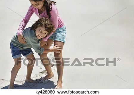 Stock Image - Children playing on the beach. Fotosearch