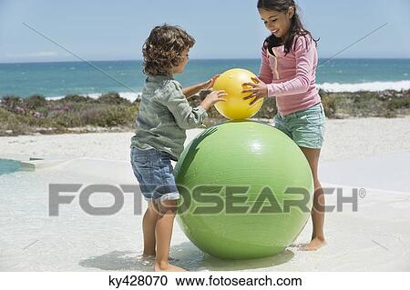 Children playing on the beach View Large Photo Image Stock Image - Children playing on the beach. Fotosearch
