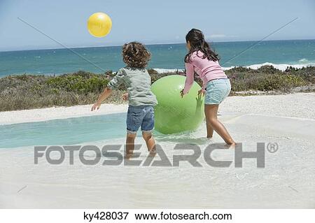 Stock Photo - Children playing on the beach. Fotosearch