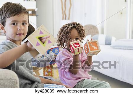 Stock Photo - Children playing with number blocks. Fotosearch