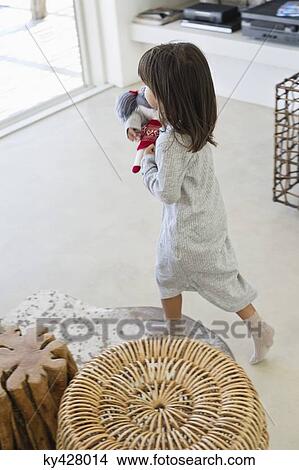 Girl carrying a rag doll View Large Photo Image Picture - Girl carrying a rag doll. Fotosearch