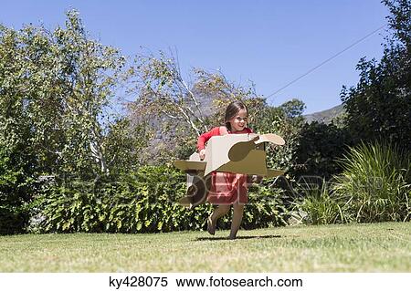 Girl playing with a cardboard airplane in lawn View Large Photo Image Stock Photography - Girl playing with a cardboard airplane in lawn. Fotosearch