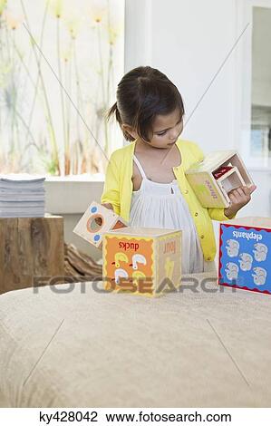 Girl playing with nested cubes View Large Photo Image Stock Image - Girl playing with nested cubes. Fotosearch