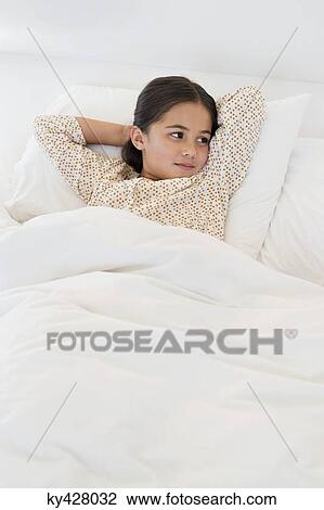 Girl relaxing on the bed View Large Photo Image Stock Image - Girl relaxing on the bed. Fotosearch