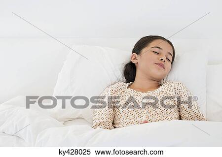Stock Photography - Girl sleeping on the bed. Fotosearch