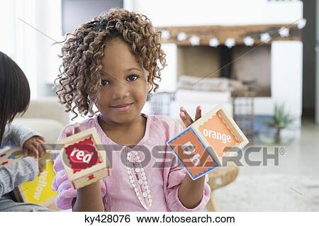 Stock Photograph - Portrait of a girl showing number blocks. Fotosearch