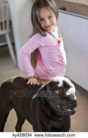 Portrait of a girl with her dog at home View Large Photo Image Picture - Portrait of a girl with her dog at home. Fotosearch