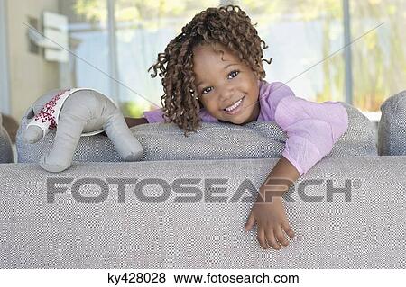 Portrait of a smiling girl holding a teddy bear View Large Photo Image Stock Photo - Portrait of a smiling girl holding a teddy bear. Fotosearch