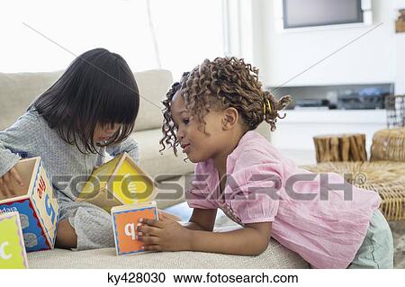 Stock Image - Two girls playing with number blocks. Fotosearch