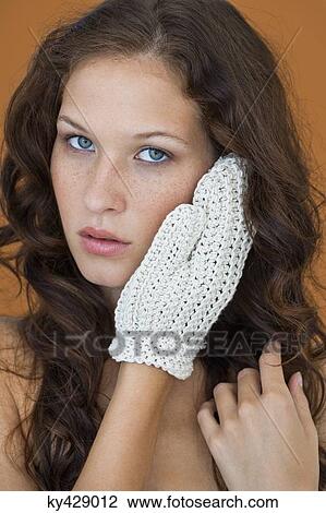 Portrait of a beautiful woman touching her face View Large Photo Image Stock Image - Portrait of a beautiful woman touching her face. Fotosearch