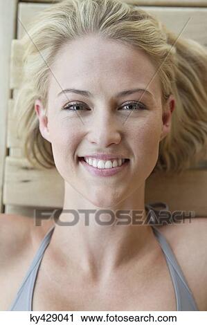 Portrait of a smiling woman resting in a sauna View Large Photo Image Stock Image - Portrait of a smiling woman resting in a sauna. Fotosearch