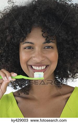 Portrait of a woman brushing her teeth View Large Photo Image Stock Image - Portrait of a woman brushing her teeth. Fotosearch