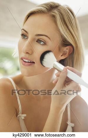 Woman applying make-up with a brush View Large Photo Image Stock Image - Woman applying make-up with a brush. Fotosearch
