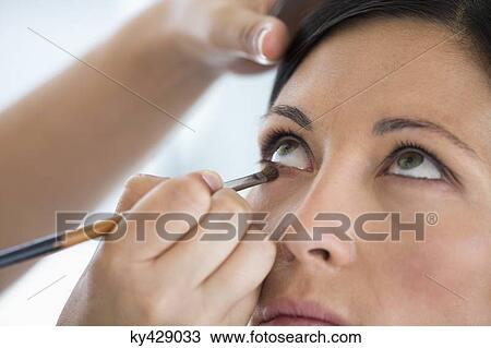 Stock Image - Woman applying mascara. Fotosearch