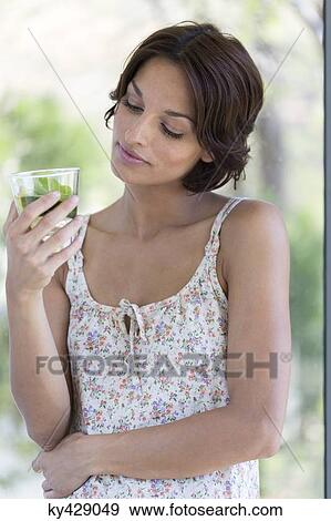 Stock Photo - Woman drinking herbal tea. Fotosearch