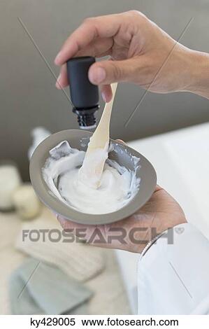 Stock Photography - Woman preparing hair dye. Fotosearch