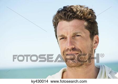 Close-up of a man on the beach View Large Photo Image Picture - Close-up of a man on the beach. Fotosearch