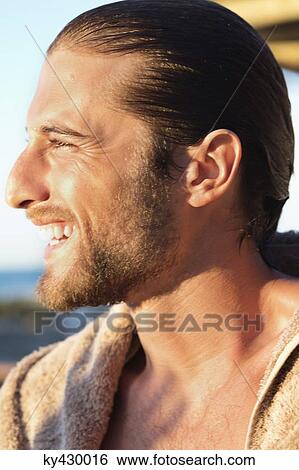 Close-up of a man smiling View Large Photo Image Stock Photograph - Close-up of a man smiling. Fotosearch
