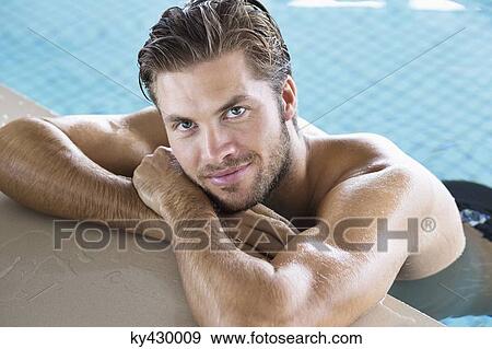 Man leaning at the edge of a swimming pool View Large Photo Image Stock Photo - Man leaning at the edge of a swimming pool. Fotosearch