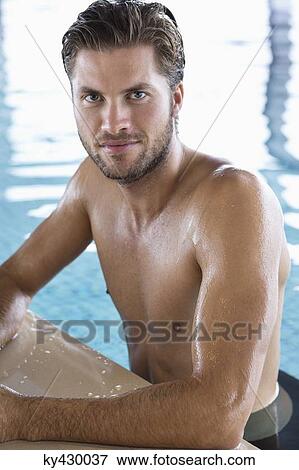 Man leaning at the edge of a swimming pool View Large Photo Image Stock Photo - Man leaning at the edge of a swimming pool. Fotosearch
