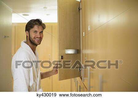 Portrait of a man smiling in a locker room of a spa View Large Photo Image Stock Photo - Portrait of a man smiling in a locker room of a spa. Fotosearch