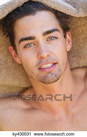 Stock Image - Portrait of a man with a towel. Fotosearch