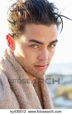 Stock Image - Portrait of a man wrapped in a towel. Fotosearch