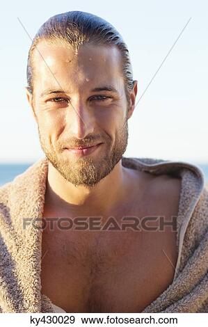 Portrait of a man wrapped in a towel and smiling View Large Photo Image Stock Photo - Portrait of a man wrapped in a towel and smiling. Fotosearch