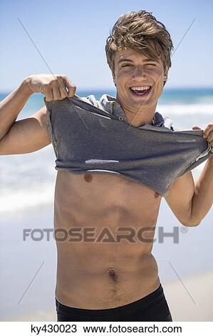 Smiling man showing his muscles View Large Photo Image Stock Image - Smiling man showing his muscles. Fotosearch
