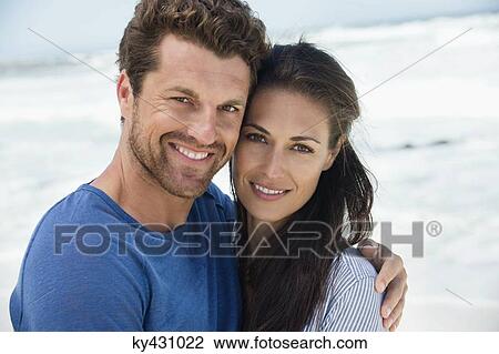 Stock Image - Close-up of a happy couple on the beach. Fotosearch