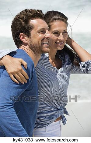 Stock Photo - Close-up of a happy couple on the beach. Fotosearch
