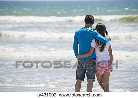 Stock Image - Couple enjoying good time on the beach. Fotosearch