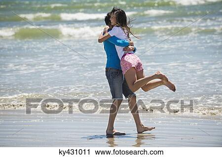 Couple enjoying good time on the beach View Large Photo Image Stock Image - Couple enjoying good time on the beach. Fotosearch
