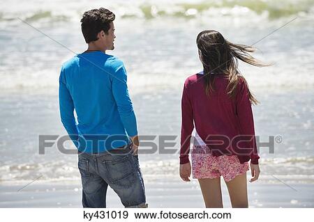 Couple enjoying good time on the beach View Large Photo Image Stock Photo - Couple enjoying good time on the beach. Fotosearch