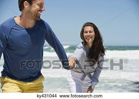 Couple enjoying on the beach View Large Photo Image Picture - Couple enjoying on the beach. Fotosearch