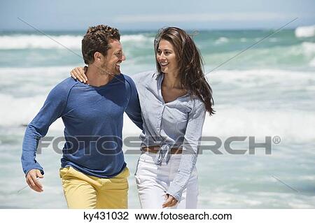 Couple enjoying on the beach View Large Photo Image Stock Image - Couple enjoying on the beach. Fotosearch
