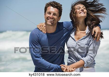Couple enjoying on the beach View Large Photo Image Stock Photo - Couple enjoying on the beach. Fotosearch