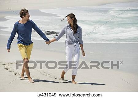 Couple enjoying on the beach View Large Photo Image Stock Photo - Couple enjoying on the beach. Fotosearch